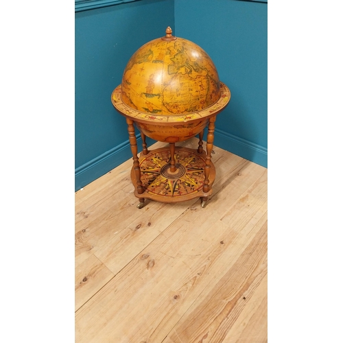 146 - Drinks cabinet in the form of a world globe raised on barley twist legs {96 cm H x 60 cm Dia.}.