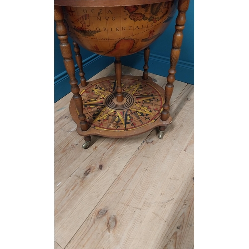 146 - Drinks cabinet in the form of a world globe raised on barley twist legs {96 cm H x 60 cm Dia.}.