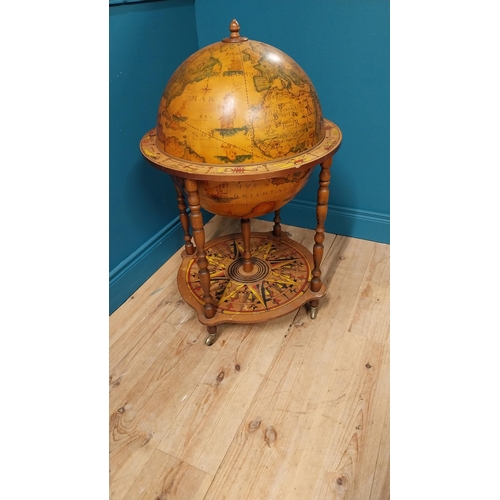 146 - Drinks cabinet in the form of a world globe raised on barley twist legs {96 cm H x 60 cm Dia.}.