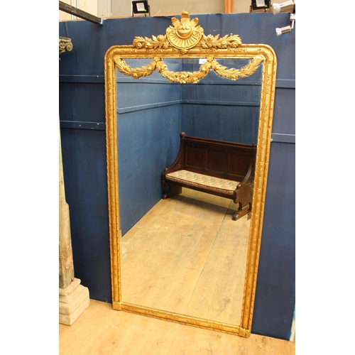 183 - French gilt wall mirror with floral swag decoration {H 235cm x W 120cm x D 6cm}.