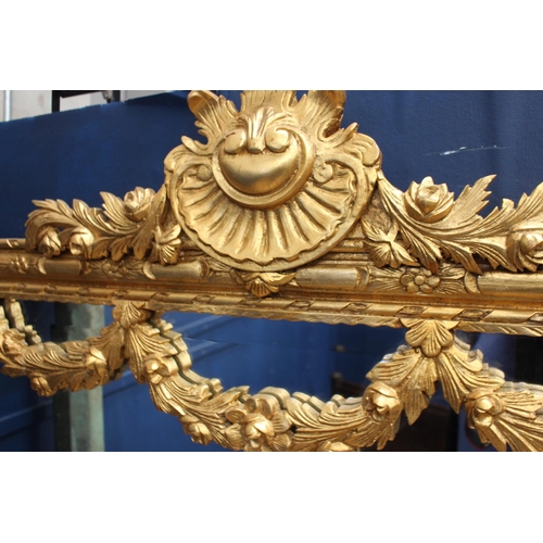 183 - French gilt wall mirror with floral swag decoration {H 235cm x W 120cm x D 6cm}.