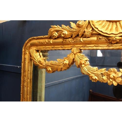 183 - French gilt wall mirror with floral swag decoration {H 235cm x W 120cm x D 6cm}.