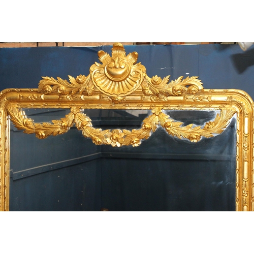 183 - French gilt wall mirror with floral swag decoration {H 235cm x W 120cm x D 6cm}.