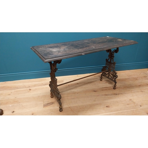 21 - 19th C. decorative cast iron table with ebonised top {73 cm H x 121 cm W x 54 cm D}.