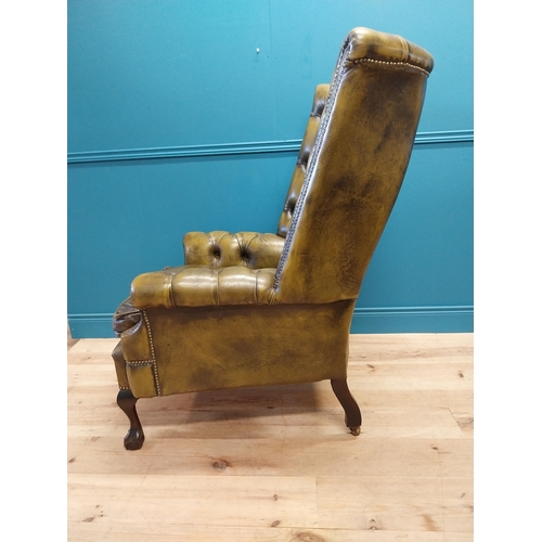 227 - Good quality hand died deep buttoned leather wingback arm chair in the Georgian style {123 cm H x 82... 