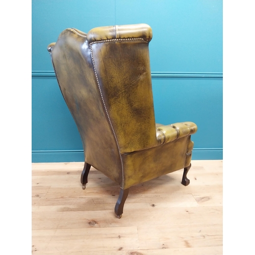 227 - Good quality hand died deep buttoned leather wingback arm chair in the Georgian style {123 cm H x 82... 