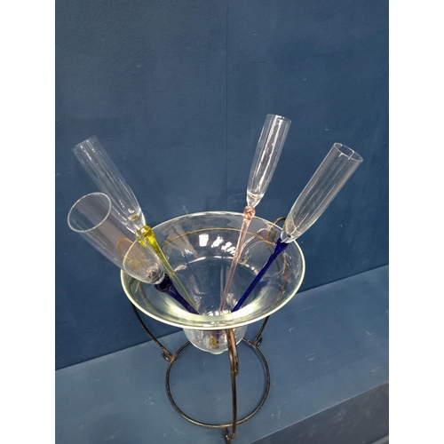 228 - Set of four champagne flutes with metal and glass bowl.