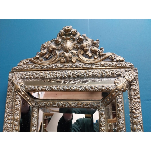 245 - Victorian embossed brass cushion mirror with candle holders {60 cm H x 40 cm W x 20 cm D}.