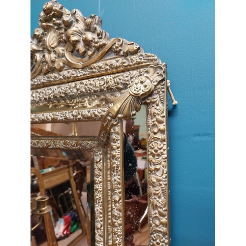 245 - Victorian embossed brass cushion mirror with candle holders {60 cm H x 40 cm W x 20 cm D}.