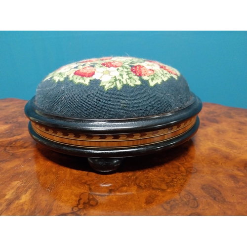 250 - 19th C. ebonised and satinwood pin cushion with tapestry upholstery {12 cm H x 28 cm Dia.}.