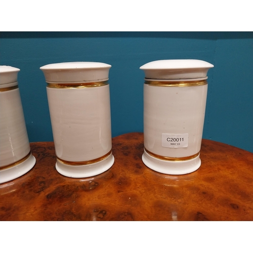 260 - Set of six early 20th C. ceramic and gilded lidded chemist jars {16 cm H x 11 cm Dia.}.