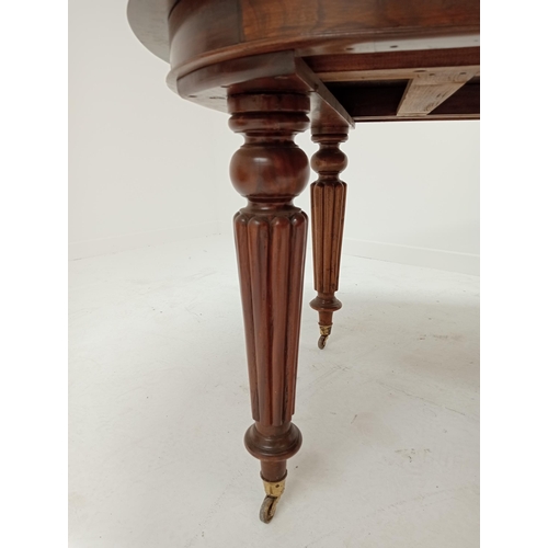 263 - Mahogany extendable table raised on turned reeded legs. {75cm H x 200cm W x 106cm D and 242cm W with... 