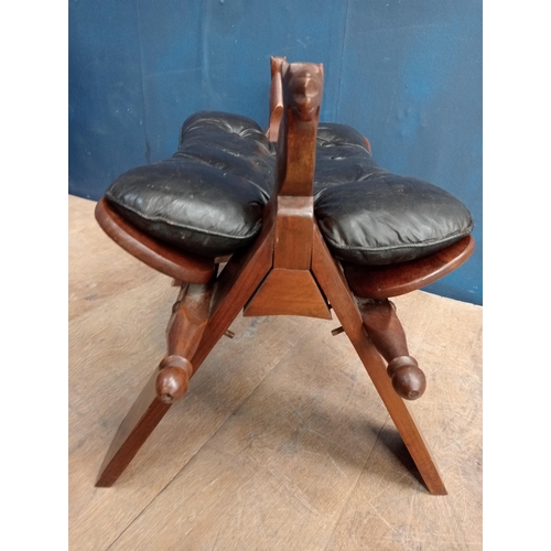 273 - Moroccan rosewood and leather upholstered camel saddle with bray inlay in the form of a stool {H 45c... 