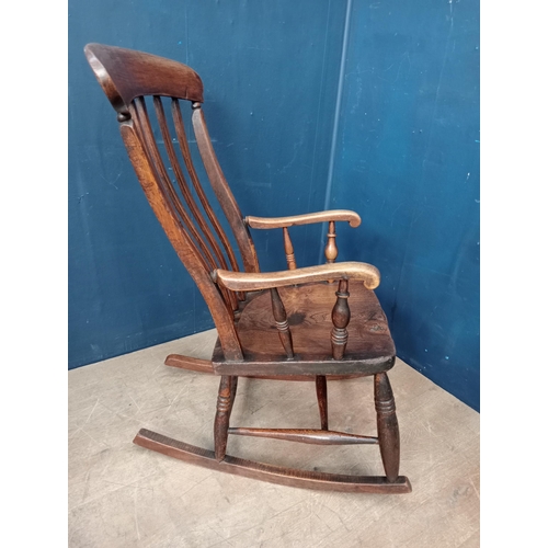 289 - Oak and elm wood slat back rocking chair {H 104cm x W 54cm x D 56cm }.