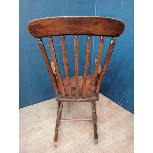 289 - Oak and elm wood slat back rocking chair {H 104cm x W 54cm x D 56cm }.