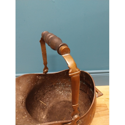 290 - Early 19th C. copper coal helmet with ebony handle {50 cm H x 31 cm W x 48 cm D}.