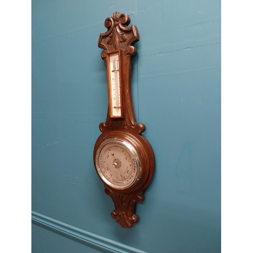 295 - Edwardian carved oak barometer with silvered dial {75 cm H x 24 cm W}.