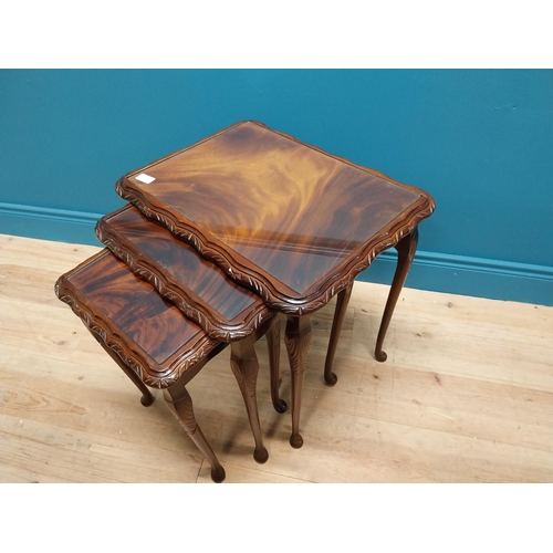 301 - 1950s mahogany nest of three tables with inset glass tops {75 cm H x 54 cm W x 41 cm D}.