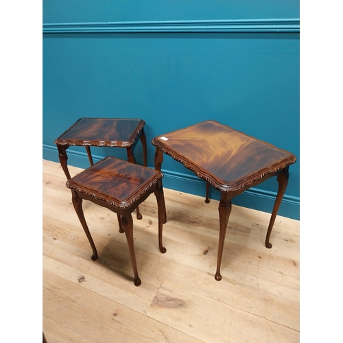 301 - 1950s mahogany nest of three tables with inset glass tops {75 cm H x 54 cm W x 41 cm D}.