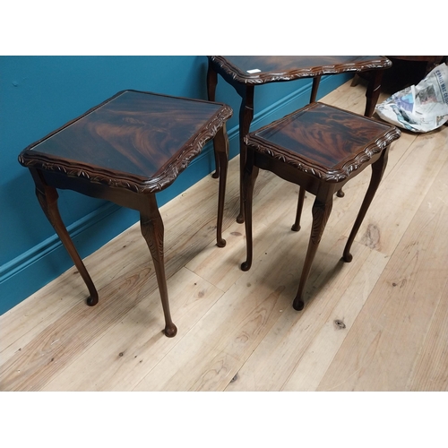 301 - 1950s mahogany nest of three tables with inset glass tops {75 cm H x 54 cm W x 41 cm D}.