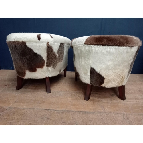 303 - Pair of cow hide tub chairs raised on square tapered legs {H 70cm x W 80cm x D 70cm }.