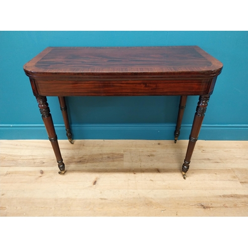 347 - Georgian mahogany and rosewood turn over leaf card table raised on turned legs and brass castors {73... 