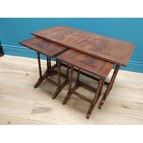 357 - Mahogany nest of three tables raised on turned columns and platform feet {48 cm H x 76 cm W x 41 cm ... 