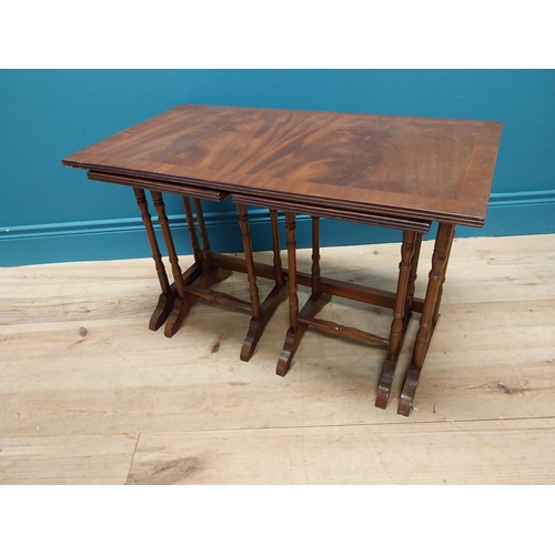 357 - Mahogany nest of three tables raised on turned columns and platform feet {48 cm H x 76 cm W x 41 cm ... 