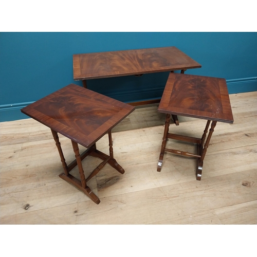 357 - Mahogany nest of three tables raised on turned columns and platform feet {48 cm H x 76 cm W x 41 cm ... 