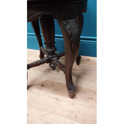 370 - Victorian carved mahogany revolving piano stool with upholstered seat {48 cm H x 34 cm Dia.}.