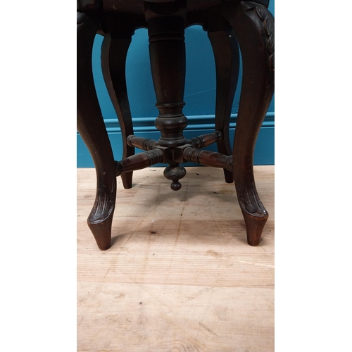 370 - Victorian carved mahogany revolving piano stool with upholstered seat {48 cm H x 34 cm Dia.}.