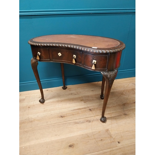 381 - Edwardian mahogany kidney shaped ladies desk with inset leather top {76 cm H x 92 cm W x 52 cm D}.