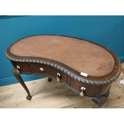 381 - Edwardian mahogany kidney shaped ladies desk with inset leather top {76 cm H x 92 cm W x 52 cm D}.