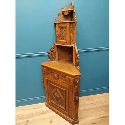 401 - Victorian carved oak corner cupboard with two blind doors and single drawer in the frieze {170 cm H ... 