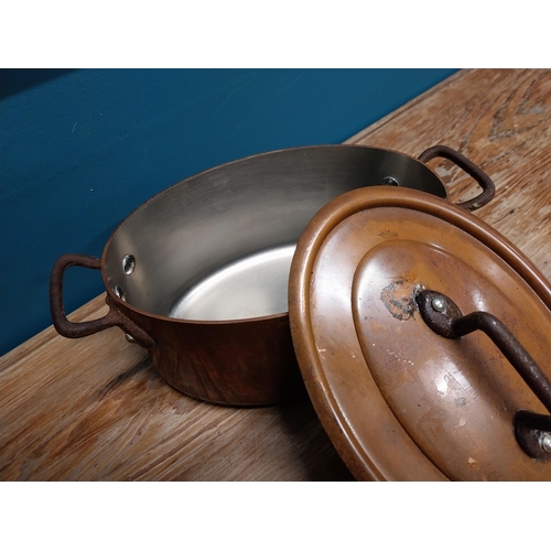 422 - Good quality 20th C. copper lidded pot with wrought iron handles {14 cm H x 26 cm W x 15 cm D}.