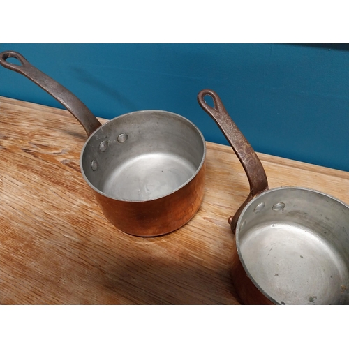 430 - Two early 20th C. hand beaten copper saucepans with wrought iron handles {16 cm H x 28 cm W x 14 cm ... 