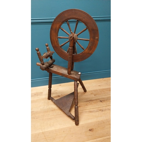 60 - Early 20th C. oak spinning wheel raised on turned legs {109 cm H x 70 cm W x 60 cm D}.