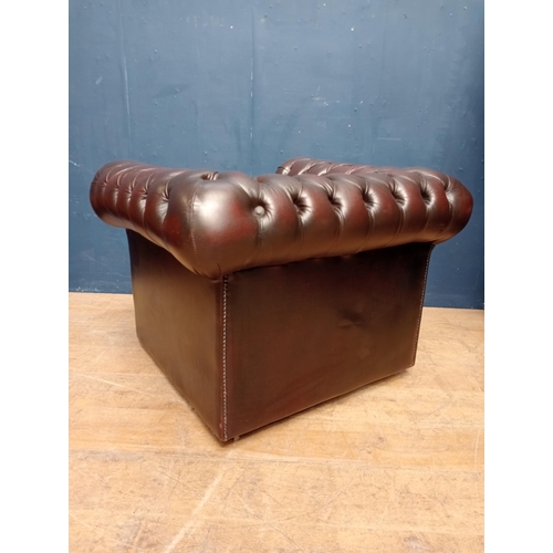 63 - Red leather deep buttoned tub chair raised on casters {H 72cm x W 100cm x D 85cm }.