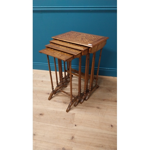 92 - Victorian walnut and satinwood inlaid nest of four tables raised on turned columns and platform feet... 