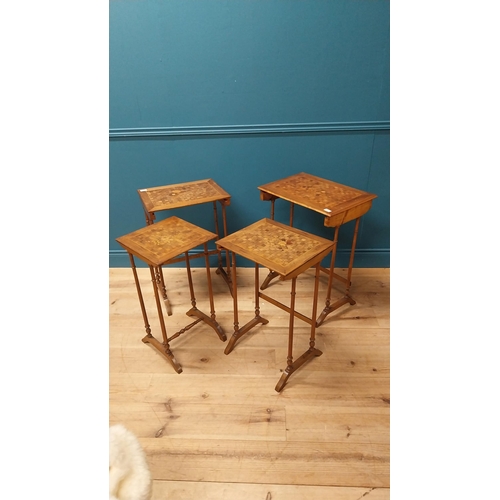 92 - Victorian walnut and satinwood inlaid nest of four tables raised on turned columns and platform feet... 