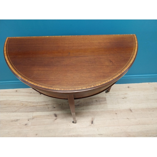 157 - Edwardian mahogany and satinwood cross banded demi lune turn over leaf card table raised on square t... 