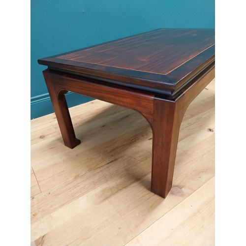 167 - Good quality mahogany and rosewood cross banded coffee table raised on square legs in the Oriental s... 