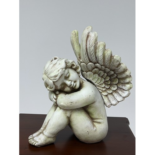 188 - Resin figure of a cherub {H 36cm x W 20cm x D 30cm }.