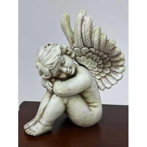 188 - Resin figure of a cherub {H 36cm x W 20cm x D 30cm }.