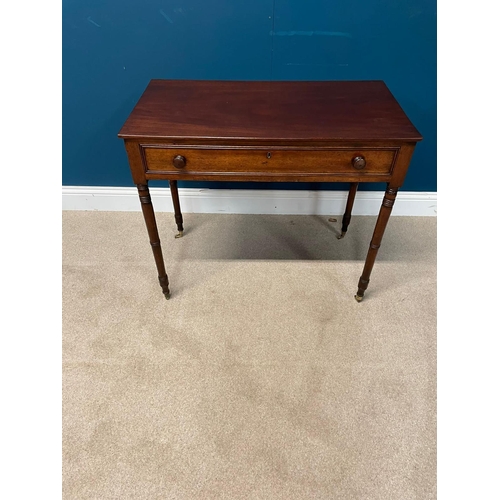 217 - 19th C. Mahogany side table with single drawer in the frieze raised on turned legs and brass castors... 