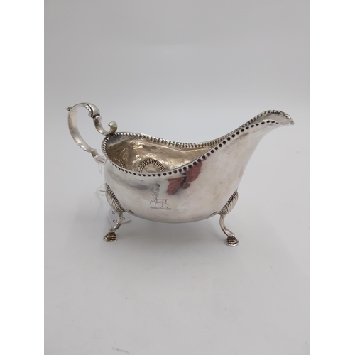 1345 - Irish silver sauce boat, decorated with beaded design, raised on shell knuckles and hoof feet and em... 