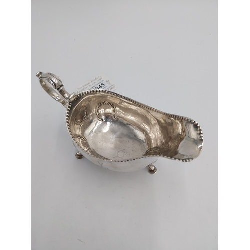 1345 - Irish silver sauce boat, decorated with beaded design, raised on shell knuckles and hoof feet and em... 