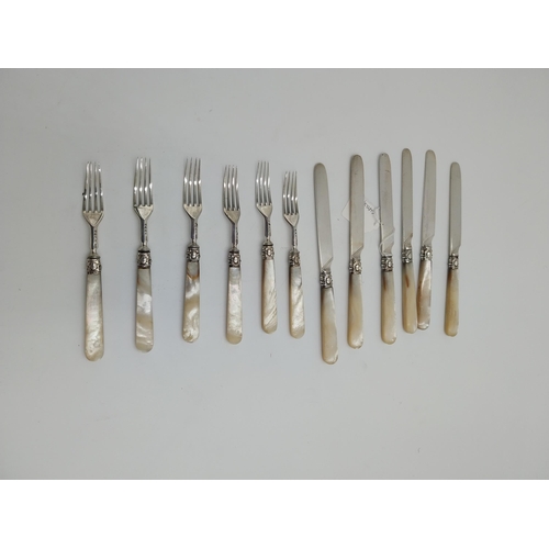 1361 - Set of six silver bladed knife and fork set with the cuffs decorated with scrolls and shields and mo... 