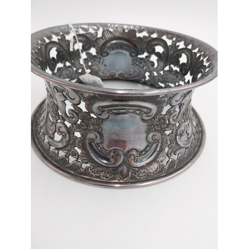 1363 - White metal dish ring / potato ring, with pierced scroll, floral decoration and two vacant cartouche... 