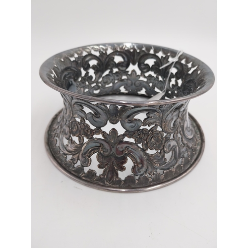 1363 - White metal dish ring / potato ring, with pierced scroll, floral decoration and two vacant cartouche... 